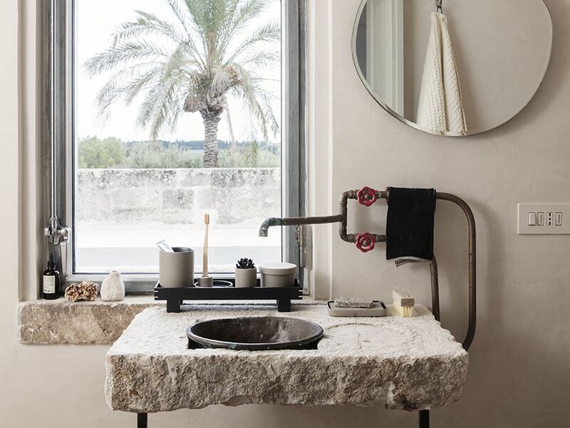 A bathroom featuring natural stone and unfinished elements