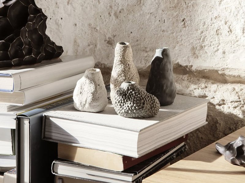 An arrangement of four small vases made from stone, an example of Japanese Interior Design by Kagu Interiors