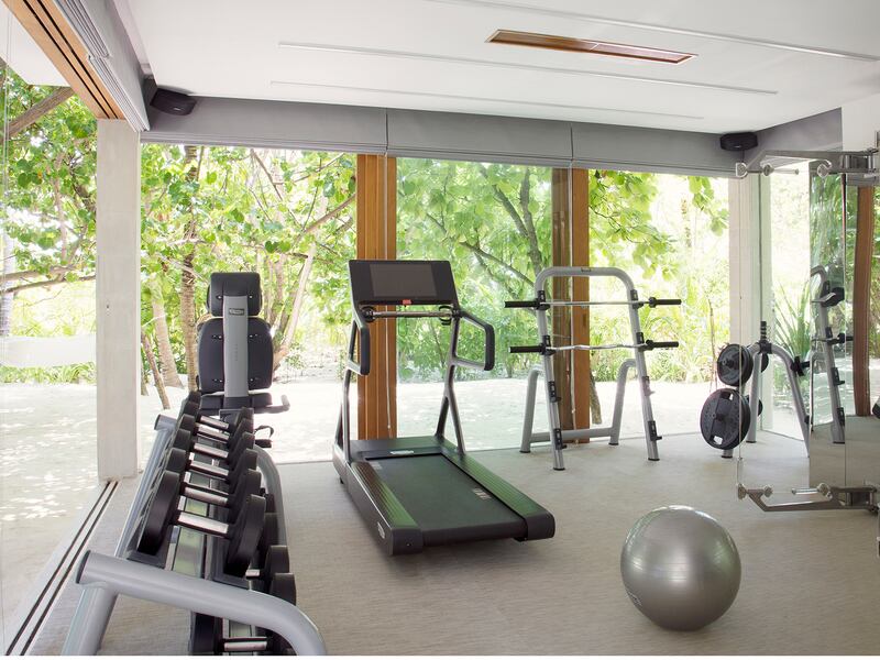 Home gym equipment in a room with floor-to-ceiling windows