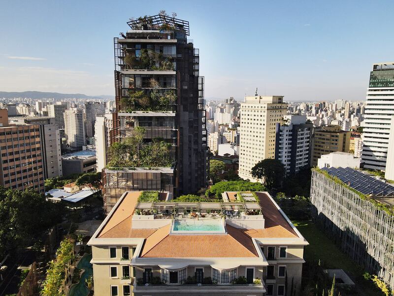 Hotel with tower and tree-filled balconies