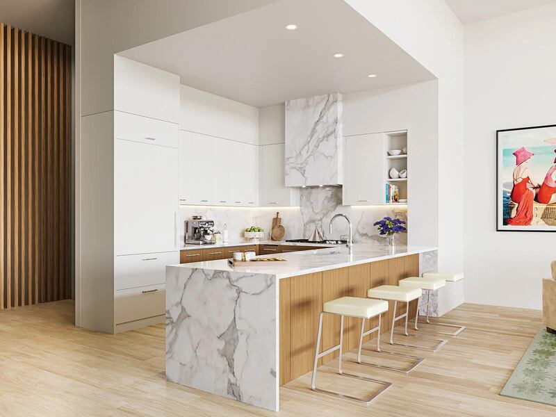 A marble kitchen island with four white stools in a while alcove.