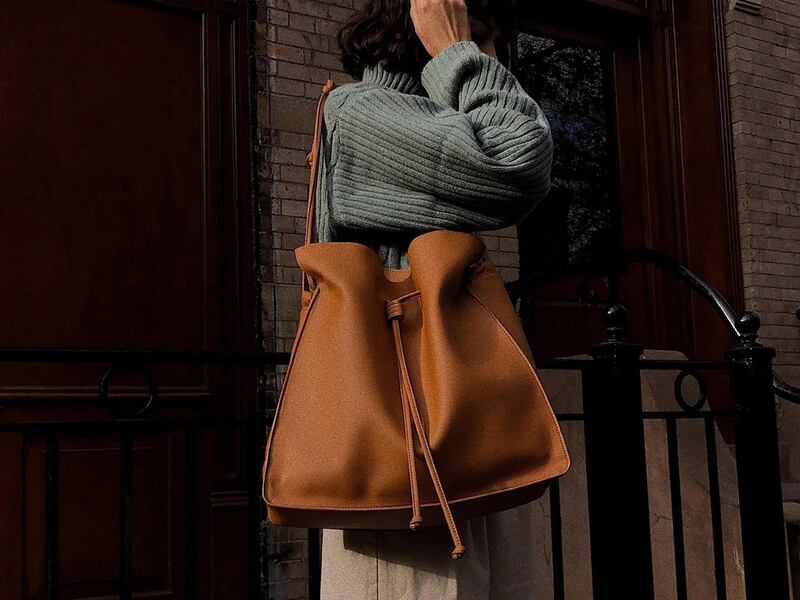 A light brown large shopper bag over a woman's shoulder