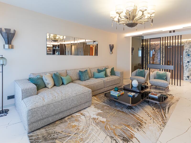 Contemporary lounge with grey sofa and teal cushions