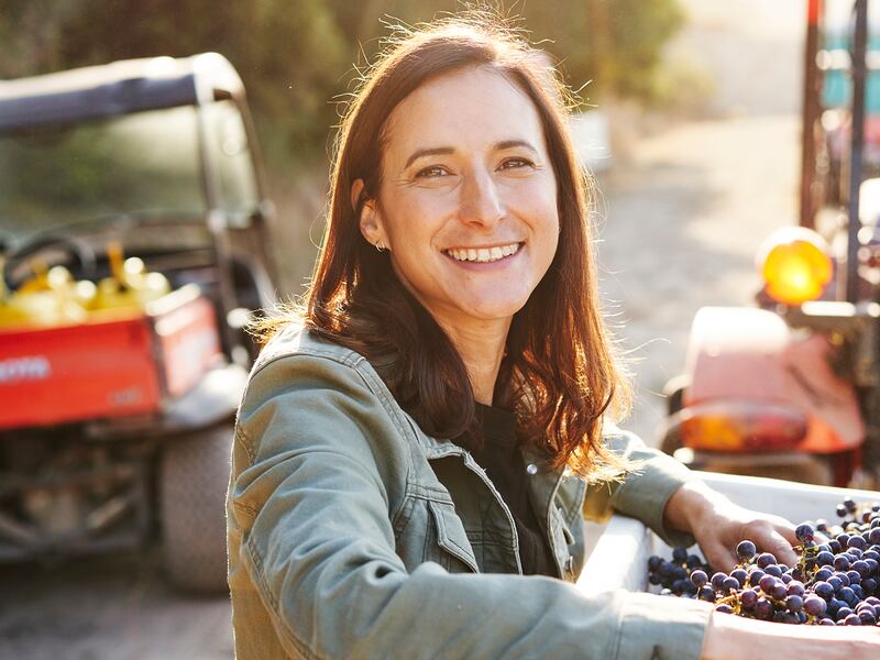 Portrait of Rebekah Wineburg in front of grape harvest