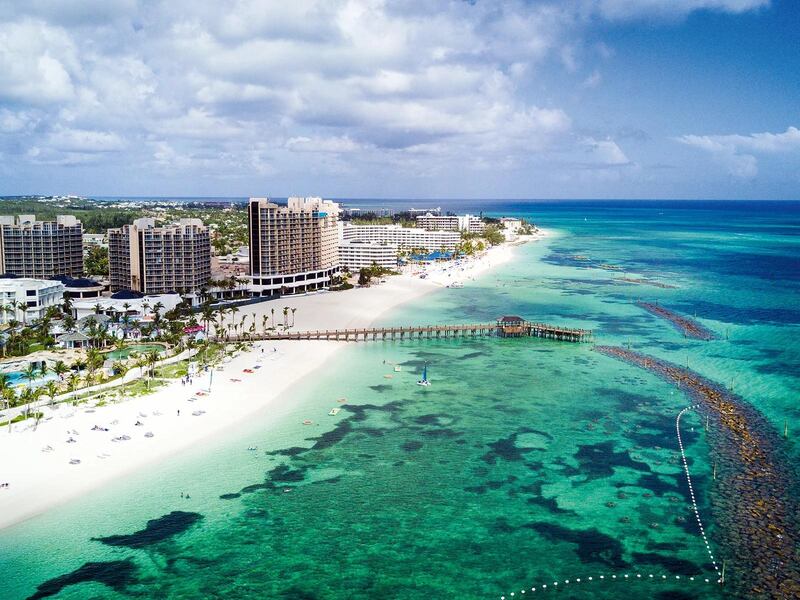 Looking west along shore of Goodman Bay, Nassau, the Bahamas. Shoreline of Grand Hyatt Baha Mar is in immediate foreground, proximal the pier, with other resorts seen in the receding distance.