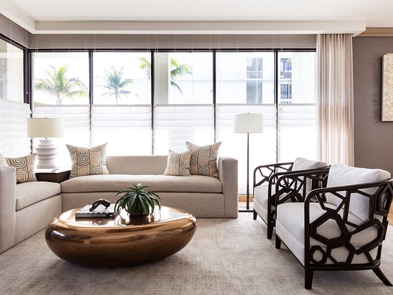A neutral living space with bold brass coffee table