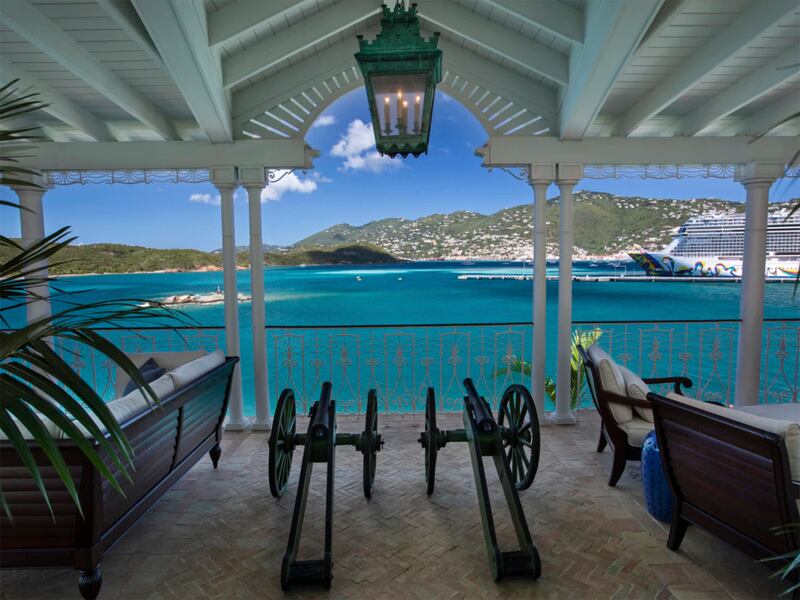 Covered deck area with seating and waterside views